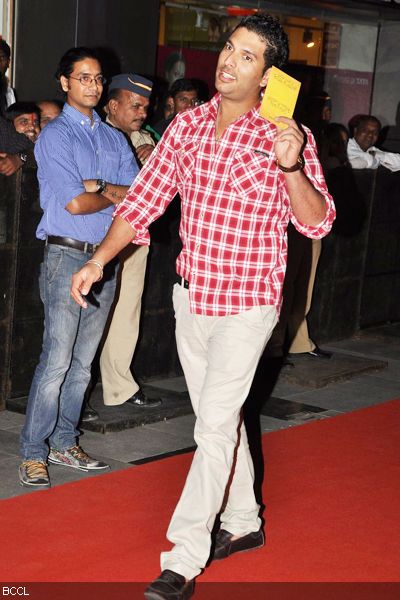 Yuvraj Singh shows off his invite as he arrives at the premiere of the movie 'Midnight's Children', held in Mumbai on January 31, 2013. (Pic: Viral Bhayani)<br /> 