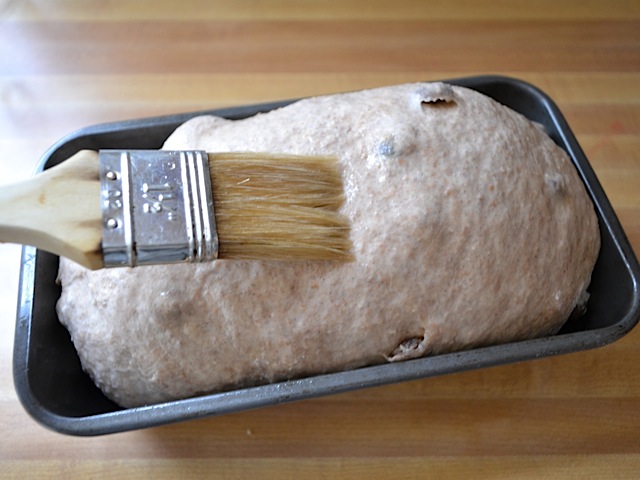 brushing the top of the loaf with water and ready to bake 