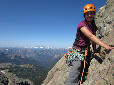 Sara at the anchor at the top of Pitch 2 with a great mountain view to the west