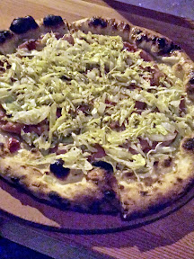Oven and Shaker's Chef Series pizza pies, starting with the November Rick Gencarelli's Mortadella Pie with an olive oil, oregano, and garlic base topped with provolone picante, Mama Lil's peppers, and mortadella then finished with shredded lettuce and dressing. Proceeds benefit Ecotrust's Farm to Schools program