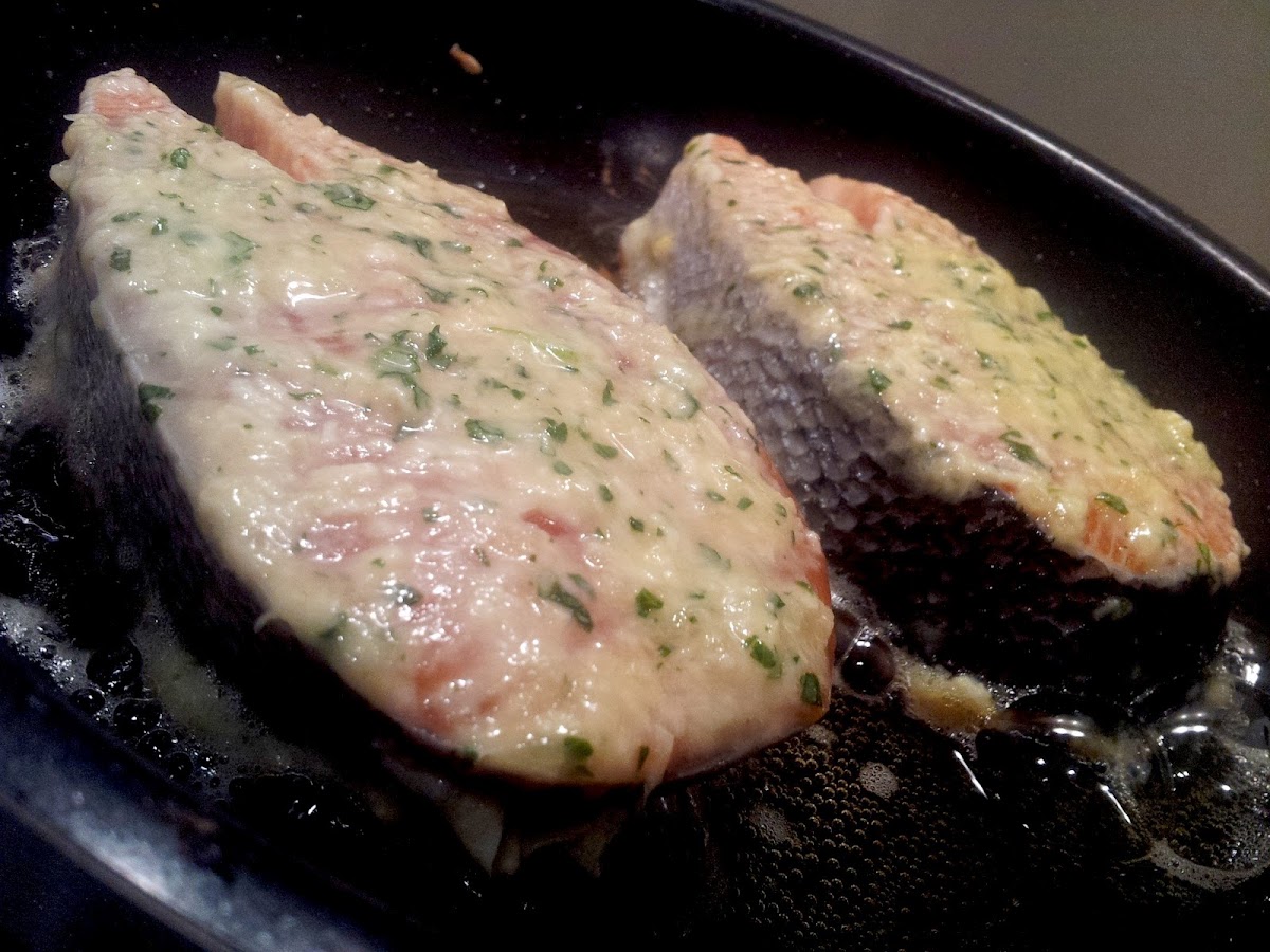 Parmesan crusted salmon frying in the pan
