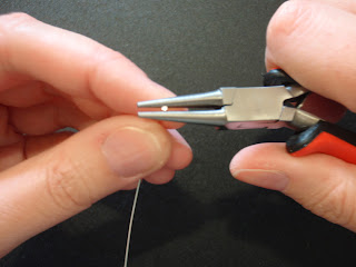Bend wire over needle nose to form a loop