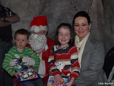 Gillian Holohan ,Bonnetstown,with her children Conor and Niamh visiting with Santa at the O'Loughlin Gaels Christmas party.