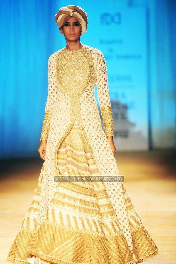A model walks the ramp for Rimple and Harpreet on Day 6 of India Couture Week, 2014, held at Taj Palace hotel, New Delhi.