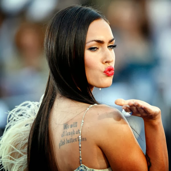 Megan Fox blows a kiss as she arrives at the premiere of Transformers at the Mann's Village theatre in Los Angeles.