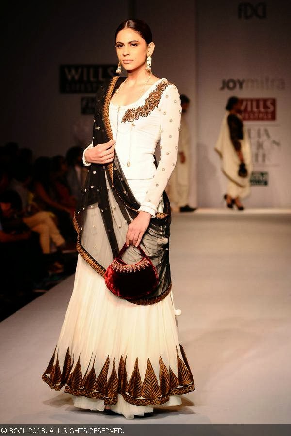 A model walks the ramp for fashion designer Joy Mitra on Day 5 of Wills Lifestyle India Fashion Week (WIFW) Spring/Summer 2014, held in Delhi.