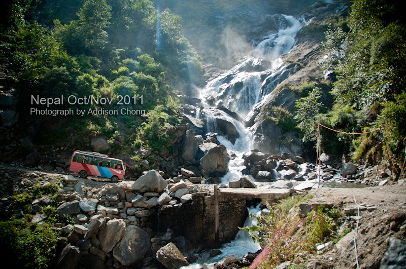Bus passing through Rupche Chahara Waterfall 