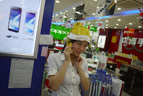 young woman wearing a sparkly yellow Santa hat in Putian, China