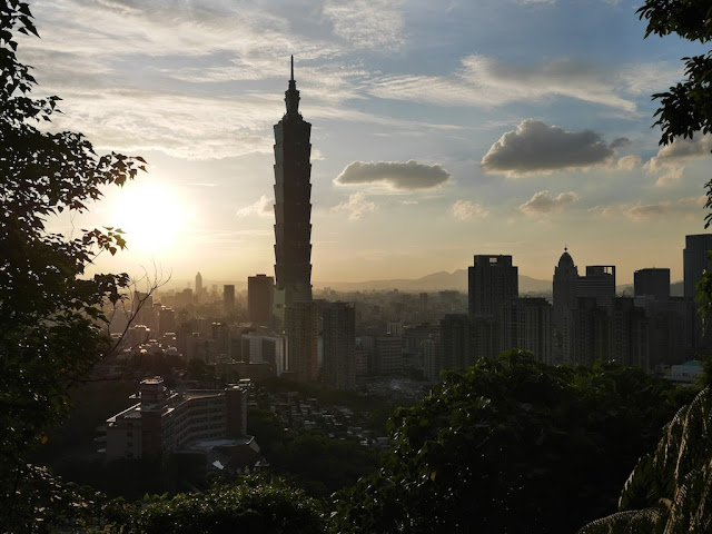 view from Xiangshan of sun setting behind Taipei 101