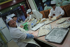 five chefs preparing dumplings in a restaurant in Yinchuan, China