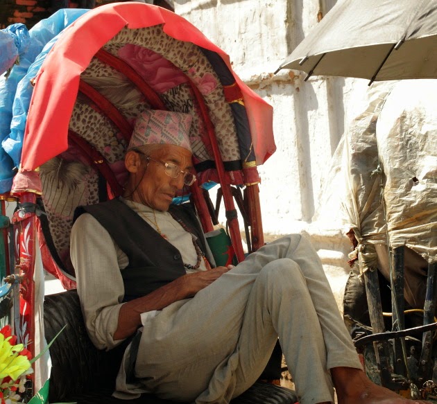 Nepali gentleman sleeping in a cycle rickshaw