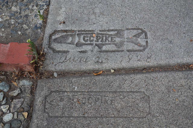 contractor's mark on the old sidewalk