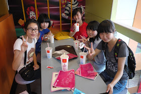Five students in Zigong posing for a photo in a McDonalds