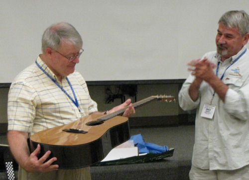 Tom Gilbert receives a gift guitar