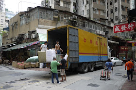 men loading a truck in Hong Kong