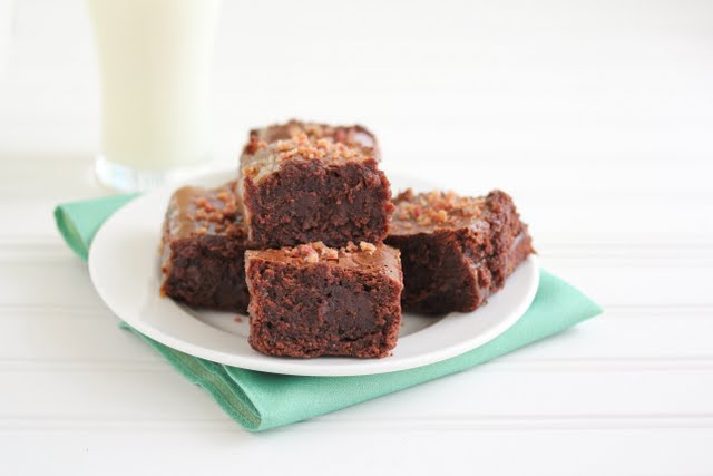 photo of a plate of brownies with a glass of milk