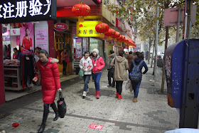 young women walking on sidewalk in Hengyang, Hunan province, China