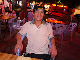man in Zhuhai, China, wearing a baseball cap with the word NRA