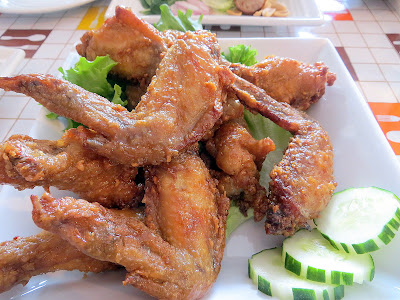 Chicken Wings, deep‐fried marinated chicken wings caramelized with sweet fish sauce Manao PDX Thai restaurant Portland Chef Chew