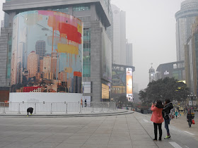 People photographing mural by Navid Baraty and YangYang Pan covering entrance to Jiefangbei Apple Store in Chongqing