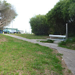 Foot path and metal seat near the Owens Walkway Car Park in Redhead (390800)