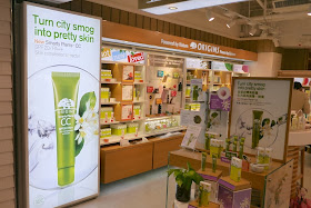 Displays at an Origins store in Hong Kong stating "Turn city smog into pretty skin"
