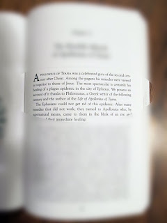 same page of text seen through glasses with the edges blurred
