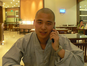 Buddhist monk talking on a mobile phone in Yangzhou, China
