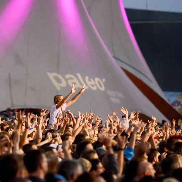 Festival goers gesture during a concert on the opening day of the 39th Paleo Festival Nyon on July 22, 2014 in Nyon, Switzerland.