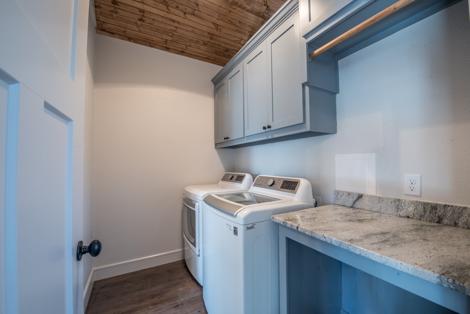 laundry room with muted blue and wood elements