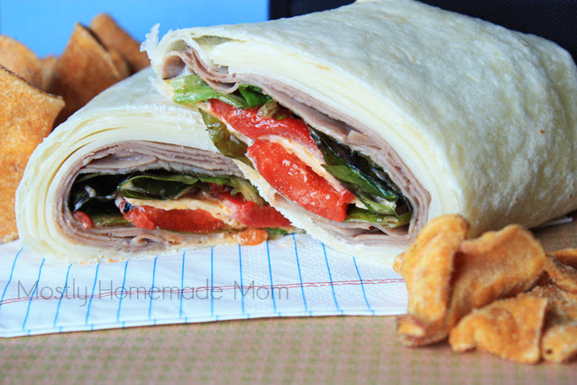 A roast beef wrap sliced in half for lunch.