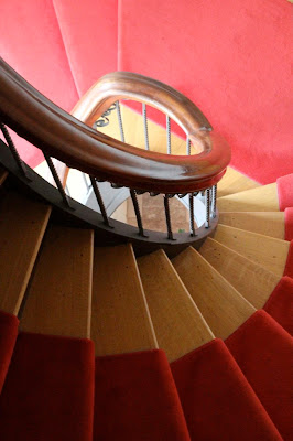 red-carpeted spiral staircase
