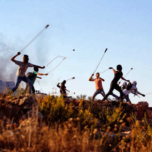 Palestinian protester hurl rocks at Israeli soldiers during clashes in Betunia, near the West Bank city of Ramallah.