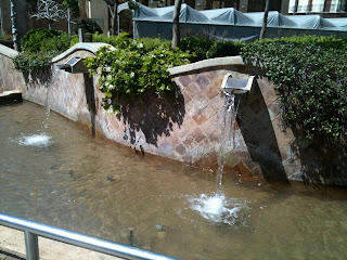 a water fountain with water falling out of it