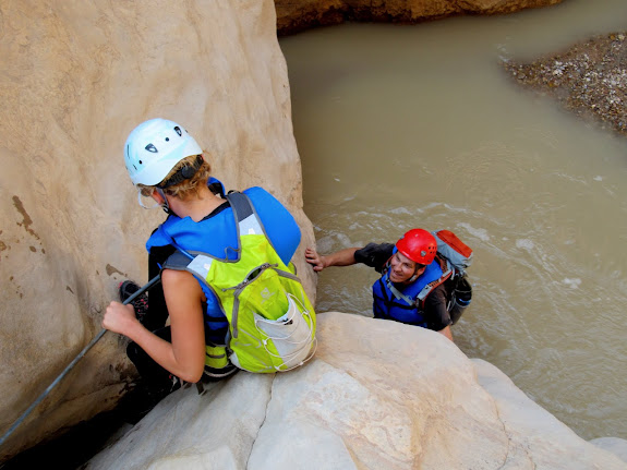 One final awkward downclimb using a handline to get into the river