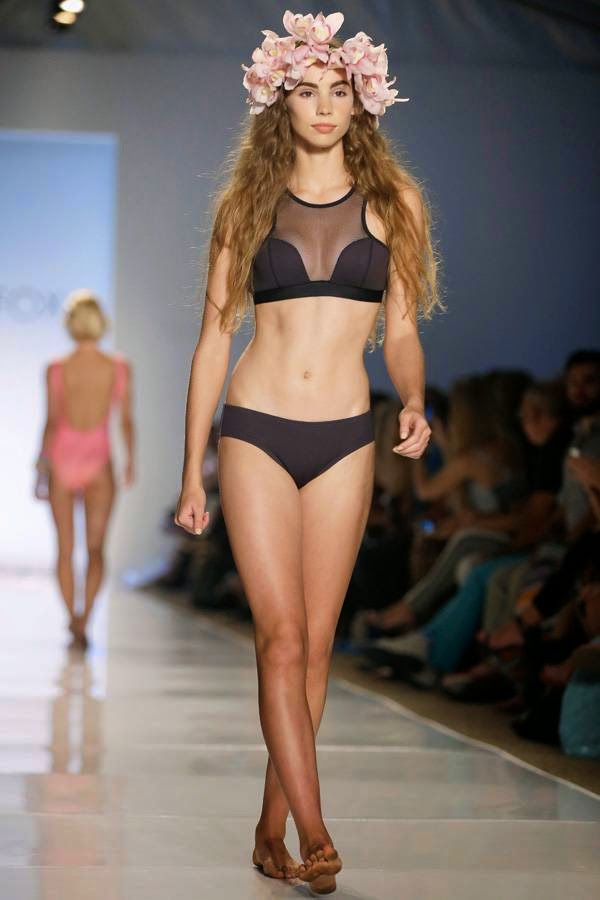 A model walks down the runway wearing swimwear designed by Wildfox during the Mercedes-Benz Fashion Week Swim show, Friday, July 18, 2014, in Miami Beach, Florida.