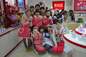 staff at Yunifang posing in costumes including Mario from Mario Bros.