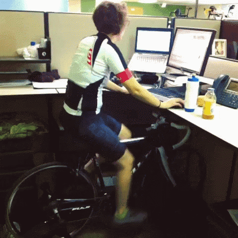 Woman peddaling bike at work desk