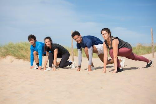 Free Couples Getting Ready to Run on the Sand Stock Photo