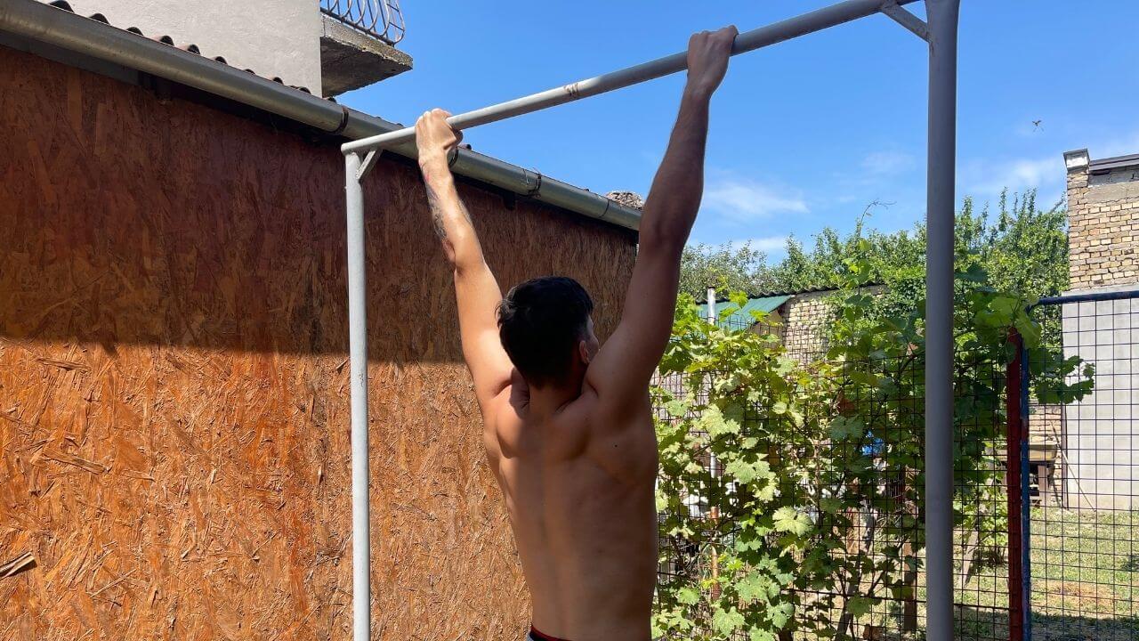 Vanja hangs from the pull-up bar outside his home.