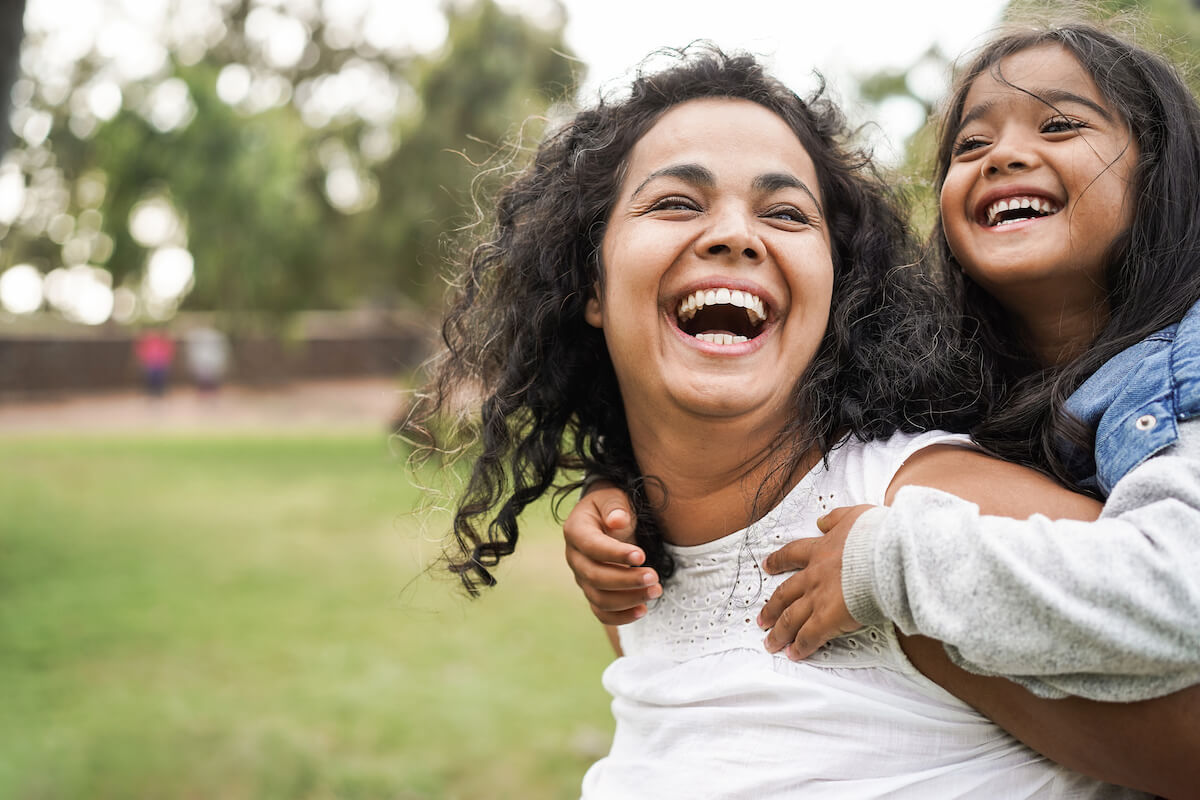 Patient engagement solutions: happy mother carrying her daughter