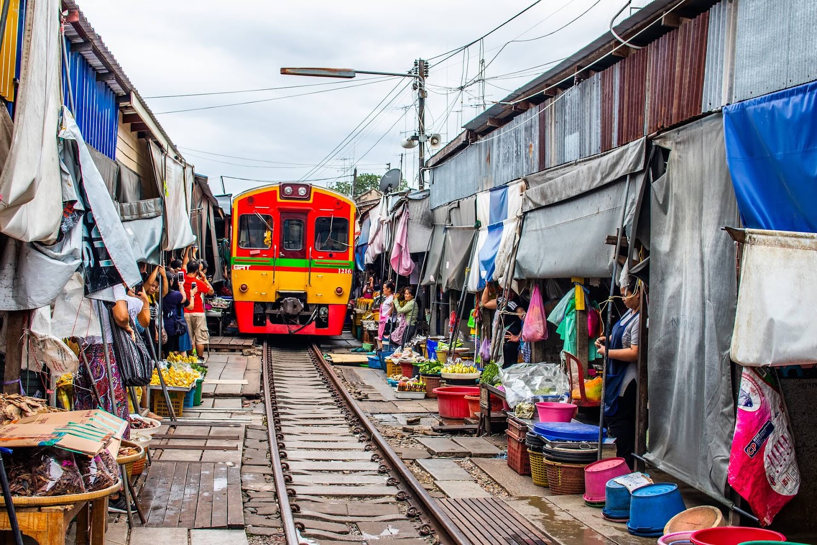 5 days 4 nights Bangkok itinerary, Maeklong Railway Market, train market, umbrella pull down market