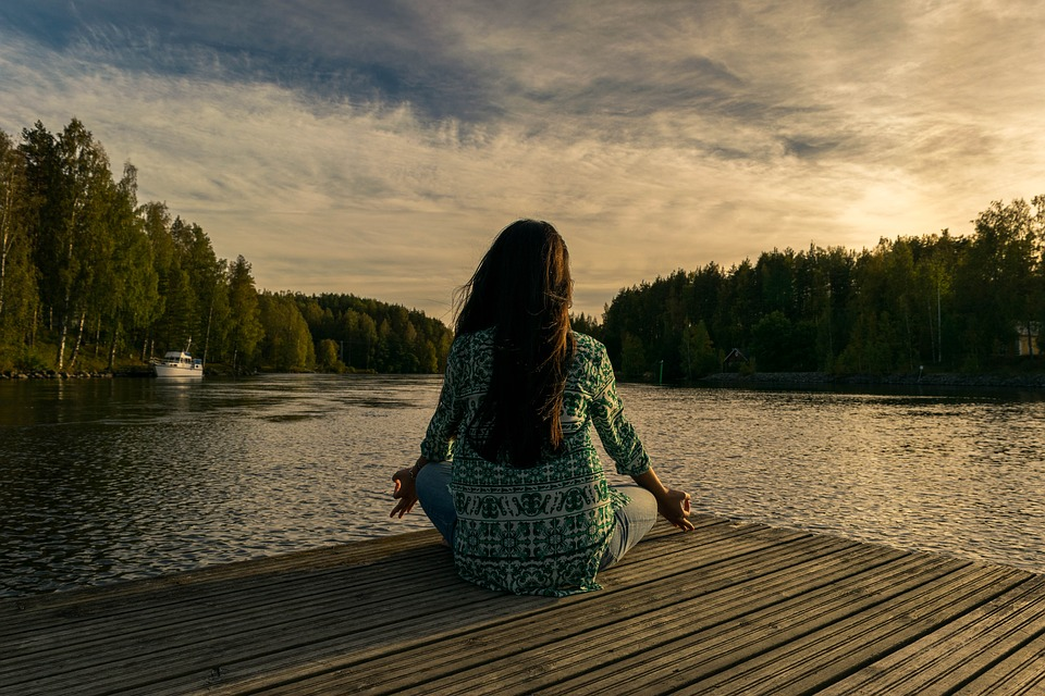 image of girl on a dock meditating