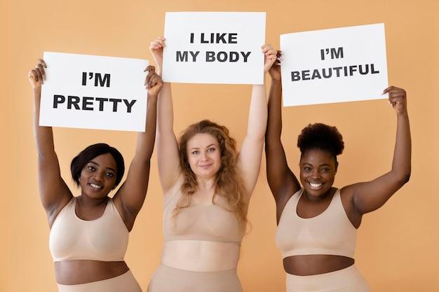 front-view-three-women-holding-placards-with-body-positivity-statements_23-2148956673
