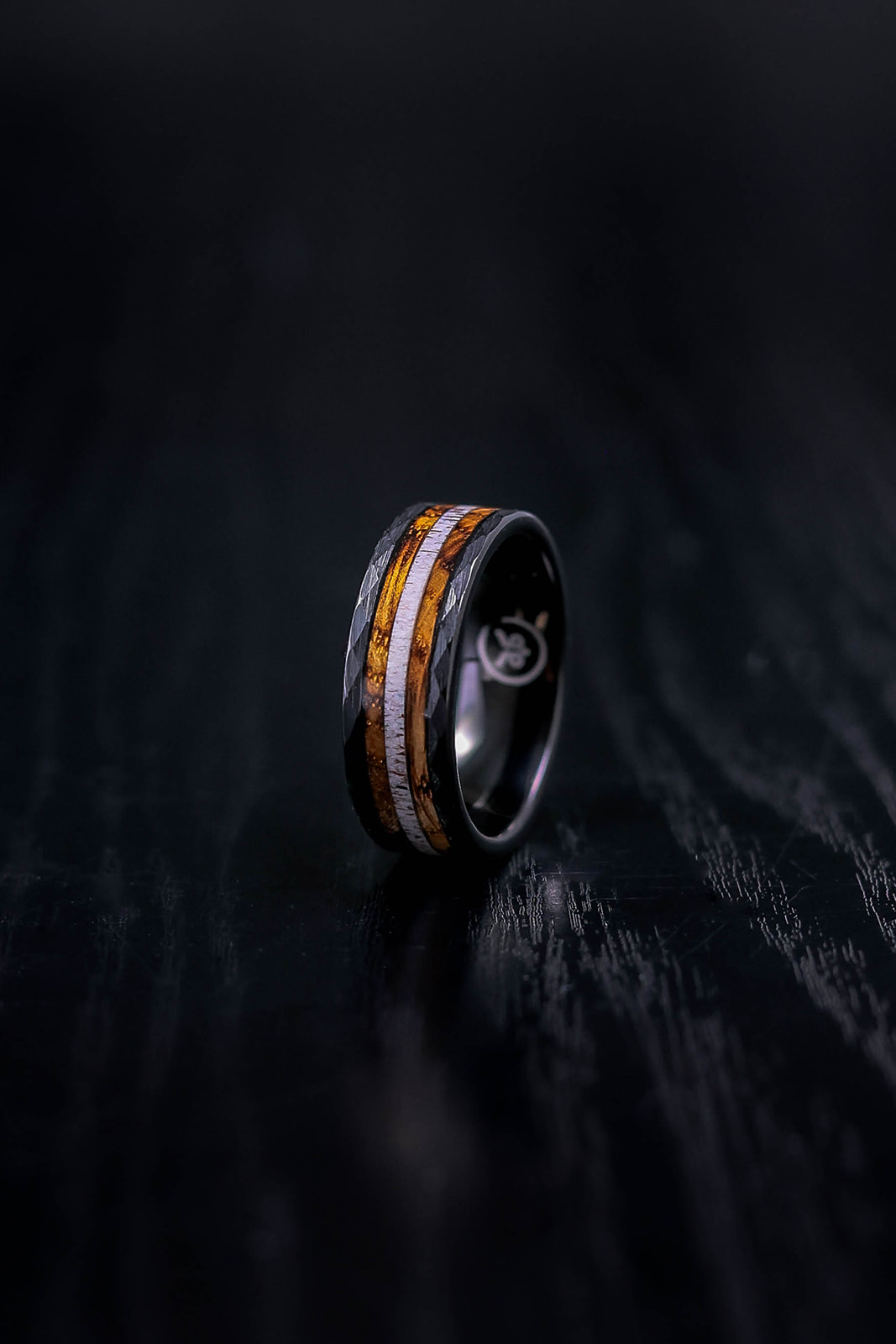 Jack Black - Black hammered tungsten wedding ring with charred whiskey barrel & deer antler inlay.