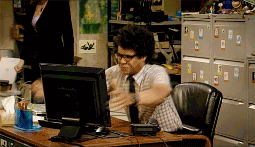 Moss from the IT Crowd furiously launching a computer acosss the room. 