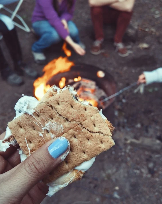 Eating S'mores over a fire