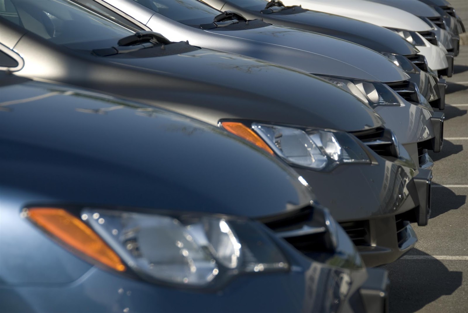 C:\Users\bunne_000\Downloads\A lineup of new cars at a dealership..jpg