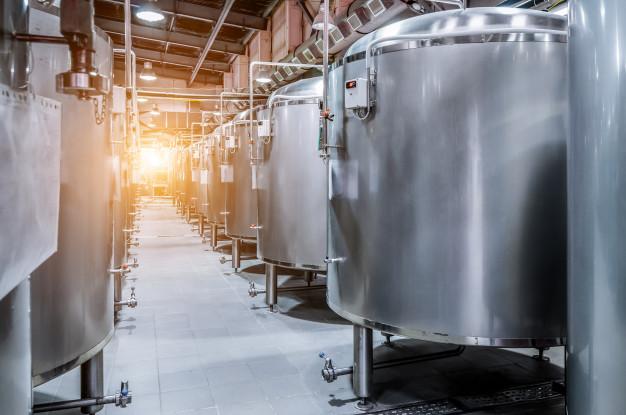 Modern beer factory. small steel tanks for fermentation of beer. Premium Photo