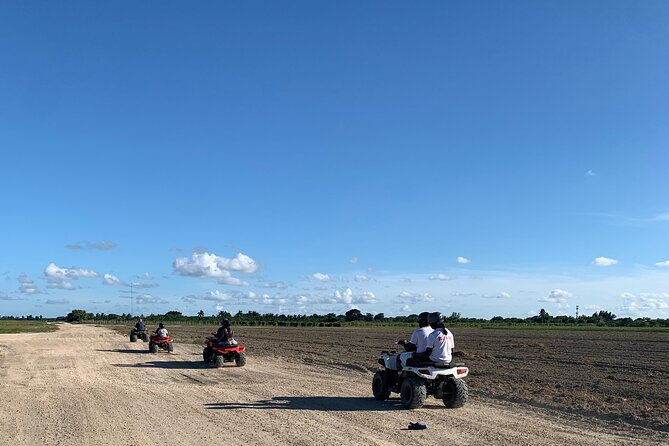 A fleet of ATVs riding through Miami, with clear blue sky above them